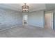 Large main bedroom with stone accent wall, plush carpet, and tray ceiling with modern lighting at 2474 Ravenswood Ct, Longmont, CO 80504