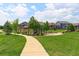 Community playground with a covered picnic area, winding sidewalk and green space at 2474 Ravenswood Ct, Longmont, CO 80504