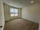 Bright bedroom with neutral carpet, paint, and a large window at 5025 N Quemoy St, Aurora, CO 80019