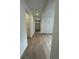 Bright hallway with hardwood floors and white walls at 5025 N Quemoy St, Aurora, CO 80019