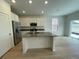 Modern kitchen showcasing an island, stainless steel appliances, and ample cabinet space at 5025 N Quemoy St, Aurora, CO 80019