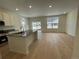 Open kitchen with island, stainless steel appliances, and stylish countertops adjacent to dining area at 5025 N Quemoy St, Aurora, CO 80019