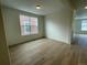 Inviting living room features sleek wood flooring and a large window for natural light at 5025 N Quemoy St, Aurora, CO 80019