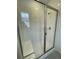 Modern shower with glass door, built-in seat, and tiled walls at 5025 N Quemoy St, Aurora, CO 80019