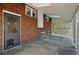 Covered back porch with brick accent wall and view of the backyard and privacy lattice at 618 S Franklin St, Denver, CO 80209