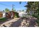 Charming brick outdoor structure with a stone patio and a fire pit in a lush backyard at 618 S Franklin St, Denver, CO 80209