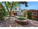 Beautiful backyard featuring a stone patio with a fire pit and mature trees at 618 S Franklin St, Denver, CO 80209