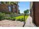 Private backyard with lush green lawn, stone patio, and charming brick exterior at 618 S Franklin St, Denver, CO 80209