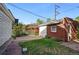 Brick shed and grassy area with stone pathway in the backyard at 618 S Franklin St, Denver, CO 80209