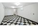 Simple basement features checkerboard tile flooring, white walls, and overhead lighting at 618 S Franklin St, Denver, CO 80209