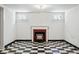 Finished basement features classic black and white tile floor and traditional fireplace with mantle at 618 S Franklin St, Denver, CO 80209