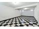 Spacious basement with checkerboard tile flooring, white walls, and bright lighting at 618 S Franklin St, Denver, CO 80209