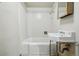 Cozy bathroom features a classic white tiled tub, shower, and pedestal sink at 618 S Franklin St, Denver, CO 80209