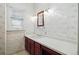 Bathroom featuring vanity with cherry cabinets, floral wallpaper and a window at 618 S Franklin St, Denver, CO 80209