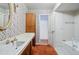 Bathroom showcases a vanity with wooden cabinets and a full bathtub adjacent to the doorway at 618 S Franklin St, Denver, CO 80209