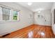 Sunlit bedroom featuring hardwood floors, neutral walls, and double windows at 618 S Franklin St, Denver, CO 80209