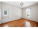 Bright bedroom with hardwood floors, a decorative chandelier, and plenty of natural light from two windows at 618 S Franklin St, Denver, CO 80209