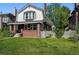 Inviting two-story home with a covered porch, brick accents, and lush green lawn at 618 S Franklin St, Denver, CO 80209
