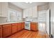 Bright kitchen featuring wood cabinets, white appliances, and hardwood floors at 618 S Franklin St, Denver, CO 80209