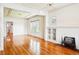 Sun-filled living room with hardwood floors, a cozy fireplace, and adjacent dining area at 618 S Franklin St, Denver, CO 80209