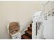 Staircase featuring a stair lift, white banister, and patterned carpet at 618 S Franklin St, Denver, CO 80209