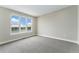 Bedroom featuring large windows with lake views, gray carpet, and a neutral color scheme at 2323 Lakeshore Ln # 11, Superior, CO 80027