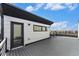 Home exterior showcasing large deck with modern railings and glass door entry at 2323 Lakeshore Ln # 11, Superior, CO 80027