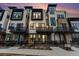 Stunning modern townhome exterior featuring private balconies and a stone and stucco facade at 2323 Lakeshore Ln # 11, Superior, CO 80027