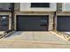 Contemporary two-car garage showcasing a sleek door with decorative rock landscaping at 2323 Lakeshore Ln # 11, Superior, CO 80027
