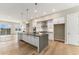 Modern kitchen with an oversized island, stainless appliances, white cabinetry, and hardwood floors at 2323 Lakeshore Ln # 11, Superior, CO 80027