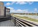 Home exterior featuring a deck with serene lake views, landscaping and community walking path at 2323 Lakeshore Ln # 11, Superior, CO 80027