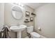 Neutral half bathroom featuring a pedestal sink and decorative wall art at 345 Harrison St, Denver, CO 80206