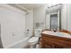 Functional bathroom with a tub and shower, vanity, and tiled walls at 345 Harrison St, Denver, CO 80206