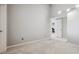 Bright, carpeted room with modern lighting and a door leading to another room at 345 Harrison St, Denver, CO 80206