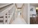 Bright hallway with tile flooring, leading to the living areas and staircase with white banister at 345 Harrison St, Denver, CO 80206