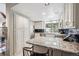 Modern kitchen with white cabinets, granite countertops, and stainless steel appliances at 345 Harrison St, Denver, CO 80206
