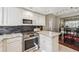 Updated kitchen features stainless steel appliances, granite countertops, and a sleek black backsplash at 345 Harrison St, Denver, CO 80206