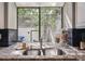 Kitchen sink with granite countertops and a large window offering views of the outdoors at 345 Harrison St, Denver, CO 80206