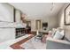 Open concept living room with a fireplace, hardwood floors, and a view into the dining area at 345 Harrison St, Denver, CO 80206