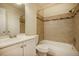 Well-lit bathroom featuring a shower-tub combination with tiled walls, complemented by a modern vanity and fixtures at 11771 Pennsylvania St, Northglenn, CO 80233