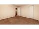 A bedroom is brightened by natural light with neutral carpet and includes a closet for storage at 11771 Pennsylvania St, Northglenn, CO 80233
