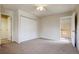 This is a cozy bedroom featuring a ceiling fan, neutral carpet, and a double closet for ample storage at 11771 Pennsylvania St, Northglenn, CO 80233