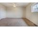 An inviting bedroom features a ceiling fan and a window that provides ample natural light at 11771 Pennsylvania St, Northglenn, CO 80233
