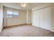Bright bedroom with neutral carpet, large closet, and ample natural light at 11771 Pennsylvania St, Northglenn, CO 80233