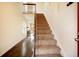 Bright entryway with hardwood floors transitioning to a carpeted staircase at 11771 Pennsylvania St, Northglenn, CO 80233