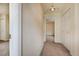 Well-lit hallway featuring neutral carpeting, closet space, and easy access to various rooms in the house at 11771 Pennsylvania St, Northglenn, CO 80233