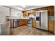 Modern kitchen with stainless steel appliances, granite countertops, and wooden cabinets at 11771 Pennsylvania St, Northglenn, CO 80233