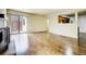 Open living room with hardwood floors, fireplace, and sliding door to the backyard at 11771 Pennsylvania St, Northglenn, CO 80233