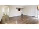 Spacious living room featuring hardwood floors and neutral paint with views to the kitchen at 11771 Pennsylvania St, Northglenn, CO 80233