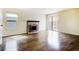 Bright living room with hardwood floors, a fireplace, and sliding glass doors at 11771 Pennsylvania St, Northglenn, CO 80233
